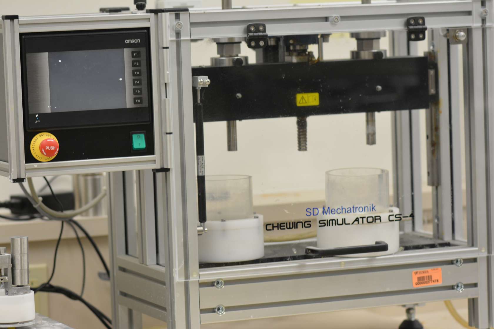 An antagonist strikes a specimen in accordance with defined parameters. The loading force is produced directly by precise weights, and is transferred to the specimen. The same load values operate in all the chambers. The use of a modern motion controller allows a whole variety of motion patterns to be programmed. This initially enables the user to program freely definable movements in both axes using the application software which is included. This allows for example the antagonist to be set to strike at minimal speed so as to reduce to a minimum the forces transferred to the specimens. The weights are freely mounted on a traverse which is raised or lowered by a servo motor. The traverse connects all the weights together so that the kinematics are identical for all antagonists, with the aim of producing comparable results. As a result of the free mounting of the weights, at the moment when the antagonist strikes the specimen only the force of the weights operates - without any losses and clearly defined. This allows a particularly precise and realistic simulation of the chewing process. The strike speed is adjustable in such a way that a defined momentum which culminates in a defined peak force is fed into the specimen. The chewing simulation in line with this procedure constitutes a standard which is applied on a worldwide basis in universities, dental clinics and by manufacturers.
