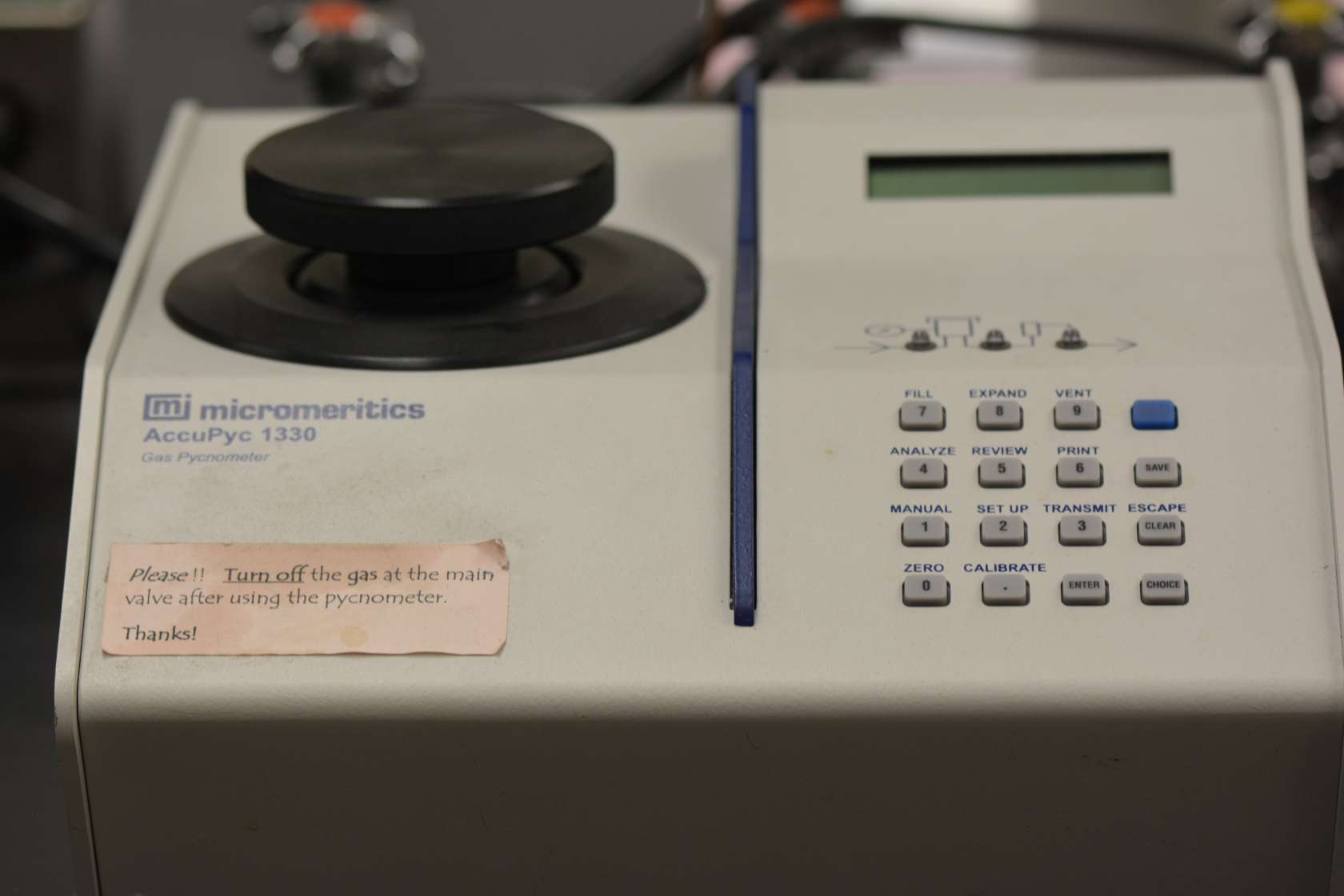 For very precise density measurements of small samples. The MicroMeritics AccuPyc 1330 Pycnometer is a fast, non destructive, fully automatic density analyzer that provides high-speed, high-precision volume and density measurements on a wide variety of materials. This pycnometer is a device that determines the density of small samples by actually measuring their volume very precisely. The sample mass is measured on a high quality balance and entered into the pycnometer software to give the sample density. The volume is measured using the Gas Displacement Technique. MicroMeritics describes it this way: The AccuPyc works by measuring the amount of displaced gas [helium]. The pressures observed upon filling the sample chamber and then discharging it into a second empty chamber allow computation of the sample solid phase volume. Gas molecules rapidly fill the tiniest pores of the sample; only the truly solid phase of the sample displaces the gas.